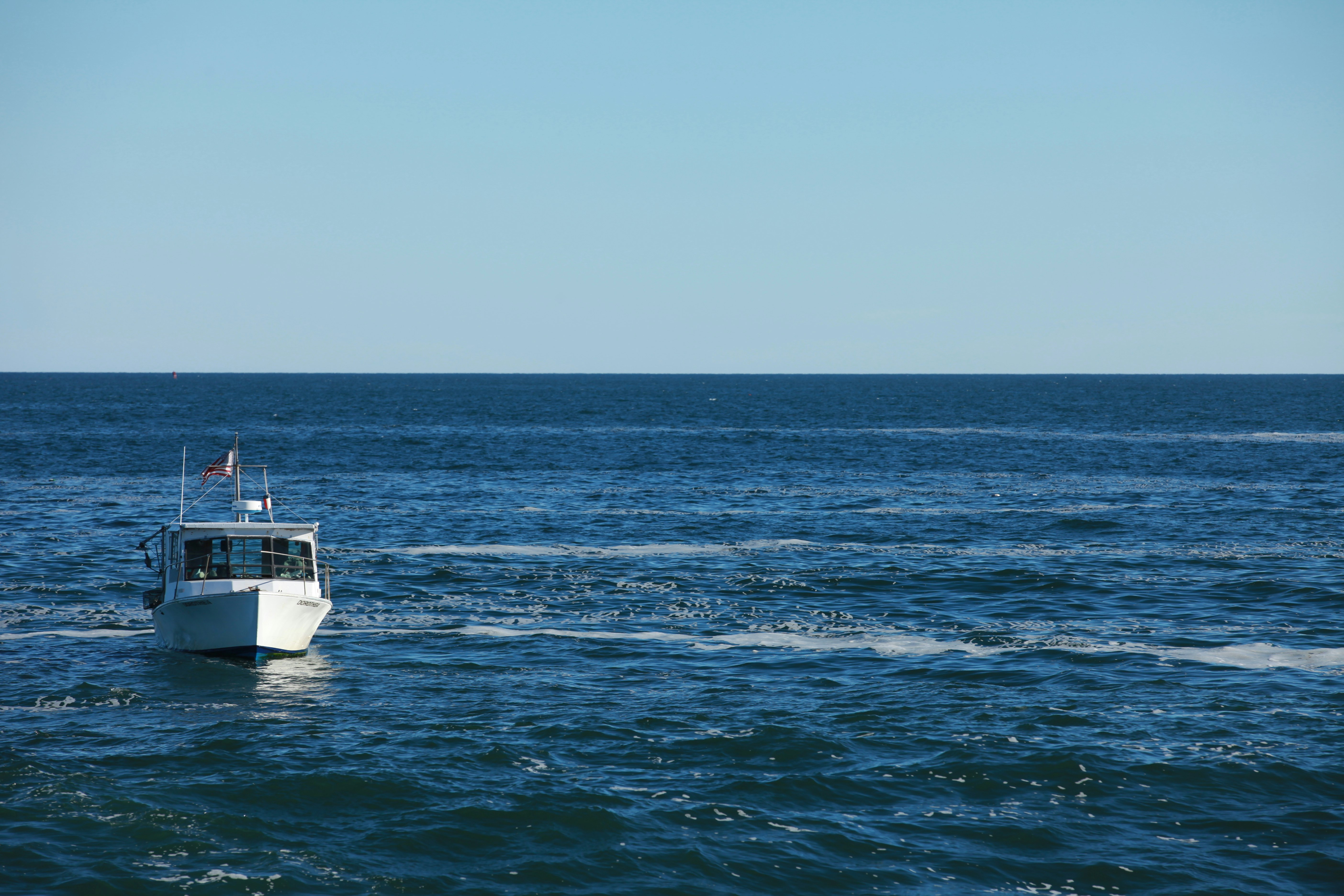 white motorboat at water